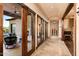 Hallway with wooden doors, a fireplace, and access to an outdoor patio at 40853 N 94Th St, Scottsdale, AZ 85262