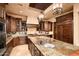 Chef's kitchen with stainless steel appliances, granite countertops, custom island, and ample storage at 40853 N 94Th St, Scottsdale, AZ 85262