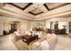 Spacious living room with decorative rug, coffered ceiling, and an open layout perfect for entertaining guests at 40853 N 94Th St, Scottsdale, AZ 85262