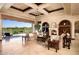 Elegant living room featuring a fireplace, coffered ceiling, and sliding glass doors to the outdoor space at 40853 N 94Th St, Scottsdale, AZ 85262