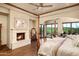 Main bedroom featuring a fireplace and desert views, creating a relaxing retreat at 40853 N 94Th St, Scottsdale, AZ 85262