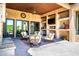 Relaxing outdoor living area with comfortable seating, stone fireplace, and golf course views at 40853 N 94Th St, Scottsdale, AZ 85262