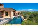 Inviting pool with a spa and beautiful desert landscaping, mountain views, and outdoor lounge area at 40853 N 94Th St, Scottsdale, AZ 85262