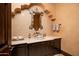 Stylish powder room with unique mirror, decorative sink, and elegant mosaic tile backsplash at 40853 N 94Th St, Scottsdale, AZ 85262