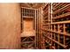 Climate-controlled wine cellar with custom wooden racks to store your extensive wine collection at 40853 N 94Th St, Scottsdale, AZ 85262