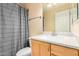Well-lit bathroom with a shower/tub combo, granite countertop, and wooden cabinets at 4354 N 82Nd St # 178, Scottsdale, AZ 85251
