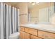 Well-lit bathroom with a shower/tub combo, granite countertop, and wooden cabinets at 4354 N 82Nd St # 178, Scottsdale, AZ 85251