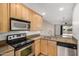 Well-lit kitchen features granite counters, stainless steel appliances, and convenient layout at 4354 N 82Nd St # 178, Scottsdale, AZ 85251