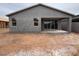 Newly constructed home shows the back exterior with a large sliding glass door to the backyard at 46886 W Coe St, Maricopa, AZ 85139
