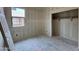 Small bedroom with an unfinished closet, concrete floors, and bright window, awaiting completion at 46886 W Coe St, Maricopa, AZ 85139