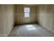 Compact bedroom with drywall, concrete floors, and a bright window, awaiting completion at 46886 W Coe St, Maricopa, AZ 85139
