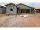 New construction home showing stucco work, scaffolding, and a dirt yard at 46886 W Coe St, Maricopa, AZ 85139