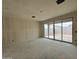 Bright living room with concrete floors and sliding glass doors leading to the outside at 46886 W Coe St, Maricopa, AZ 85139