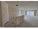 Open-concept living room featuring drywall, concrete floors, and natural light from a sliding glass door at 46886 W Coe St, Maricopa, AZ 85139