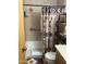 Bathroom featuring a shower/tub combo, Southwestern-themed shower curtain and decorative shelving at 5425 N Black Cyn Hwy, Phoenix, AZ 85015