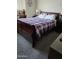 Bedroom featuring a large bed with a unique patterned blanket and a wooden frame at 5425 N Black Cyn Hwy, Phoenix, AZ 85015