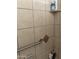 Tiled shower featuring a grab bar and corner shelving at 5425 N Black Cyn Hwy, Phoenix, AZ 85015