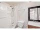 Clean bathroom featuring a shower and tub combination, a sink, and a toilet at 5529 W Virginia Ave, Phoenix, AZ 85035