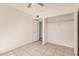 Neutral bedroom featuring tile flooring, a ceiling fan, and an open closet at 5529 W Virginia Ave, Phoenix, AZ 85035