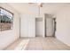 Bright bedroom features a ceiling fan, a window with security bars, and a closet at 5529 W Virginia Ave, Phoenix, AZ 85035