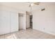 Bright bedroom featuring a ceiling fan, closet with doors and a view to another room at 5529 W Virginia Ave, Phoenix, AZ 85035