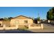 Charming single-story home with a neutral facade, low block wall, and desert landscaping at 5739 N 62Nd Dr, Glendale, AZ 85301
