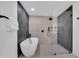 Modern bathroom features a soaking tub, glass shower, and sleek black fixtures at 6038 E Hobart St, Mesa, AZ 85205