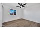 Clean bedroom with white walls, a ceiling fan and wood floors at 6038 E Hobart St, Mesa, AZ 85205