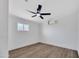 Clean bedroom with white walls, a ceiling fan and wood floors at 6038 E Hobart St, Mesa, AZ 85205
