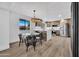 Bright, open-concept space with a glass dining table adjacent to a modern kitchen at 6038 E Hobart St, Mesa, AZ 85205