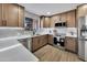 Beautiful kitchen featuring stainless steel appliances, stone countertops, and custom cabinets at 6038 E Hobart St, Mesa, AZ 85205