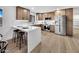 Updated kitchen with stainless steel appliances, custom cabinets, and modern countertops at 6038 E Hobart St, Mesa, AZ 85205