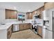 Beautiful kitchen featuring stainless steel appliances, stone countertops, and custom cabinets at 6038 E Hobart St, Mesa, AZ 85205