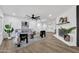 Comfortable living room with fireplace, ceiling fan, hardwood floors, and neutral color palette at 6038 E Hobart St, Mesa, AZ 85205