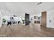 Open-concept living room features hardwood floors, modern furniture, and seamless flow to kitchen at 6038 E Hobart St, Mesa, AZ 85205