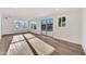 Bright living room with wood floors, multiple windows and sliding glass door leading to the backyard pool at 6038 E Hobart St, Mesa, AZ 85205