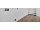 Bright utility room features wood floors, white walls and an alcove with open shelving at 6038 E Hobart St, Mesa, AZ 85205