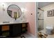 Chic bathroom featuring a modern vanity, round mirror, and a glass-enclosed shower at 6222 N 21St Dr, Phoenix, AZ 85015