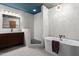 Contemporary bathroom featuring a soaking tub, walk-in shower, and modern vanity at 6222 N 21St Dr, Phoenix, AZ 85015