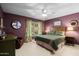 Comfortable bedroom with a window view, mauve walls, and a traditional-style bed frame at 6222 N 21St Dr, Phoenix, AZ 85015