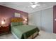 Cozy bedroom with mauve walls, a white ceiling fan, and ample closet space at 6222 N 21St Dr, Phoenix, AZ 85015