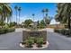 Community entrance with manicured landscaping and palm trees, in a private neighborhood at 6222 N 21St Dr, Phoenix, AZ 85015