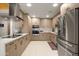 Modern kitchen featuring stainless steel appliances, light wood cabinets, and quartz countertops at 6222 N 21St Dr, Phoenix, AZ 85015
