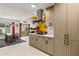 Open concept kitchen with a modern hood, light wood cabinets, and views of the dining and living areas at 6222 N 21St Dr, Phoenix, AZ 85015