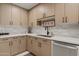Bright kitchen featuring light wood cabinets, quartz countertops, modern backsplash, and stainless appliances at 6222 N 21St Dr, Phoenix, AZ 85015