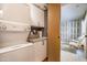 Functional laundry room with modern appliances and adjacent sitting area at 6222 N 21St Dr, Phoenix, AZ 85015
