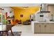 Cozy living room with a fireplace, a yellow ceiling, and a seamless transition to the modern kitchen at 6222 N 21St Dr, Phoenix, AZ 85015