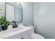 Powder room with a modern vanity, black hardware, and stylish lighting at 6565 N 19Th Ave # 45, Phoenix, AZ 85015