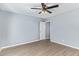 Cozy bedroom with light colored flooring, ceiling fan and an open door at 6565 N 19Th Ave # 45, Phoenix, AZ 85015