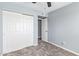 This bedroom features neutral carpet, a ceiling fan, and a double-door closet at 6565 N 19Th Ave # 45, Phoenix, AZ 85015